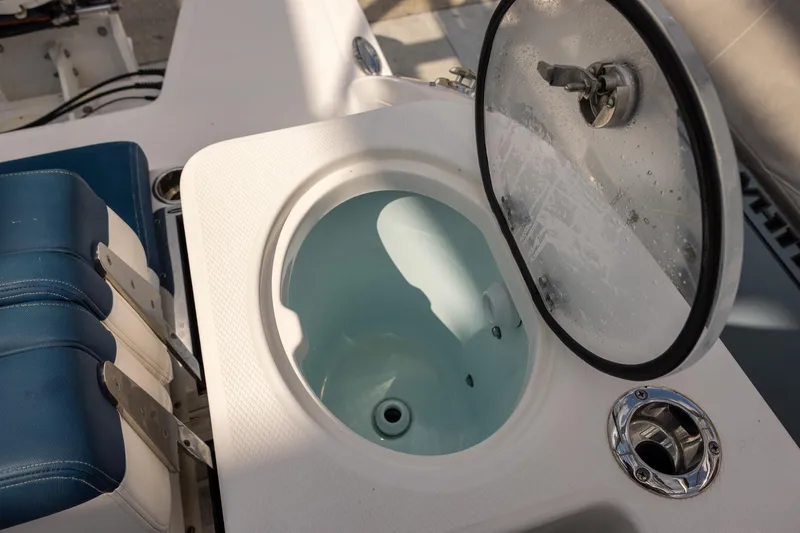 Slide: The Image of 2019 Robalo R317 Dual Console boat with open livewell and seating. - 8