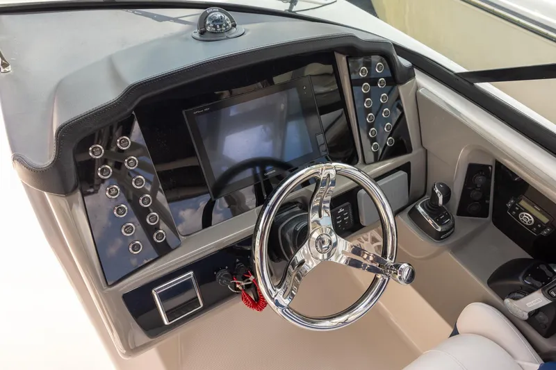 Slide: The Image of 2019 Robalo R317 Dual Console dashboard with steering wheel and control panel. - 9