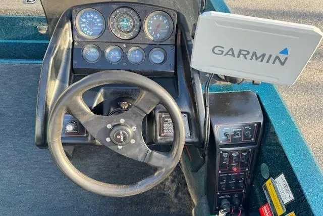 Slide: The Image of 1994 Javelin 389T boat dashboard with Garmin GPS and steering wheel. - 12