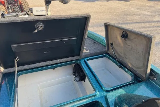 Slide: The Image of Open storage compartments on a 1994 Javelin 389T boat, featuring a Garmin device. - 15