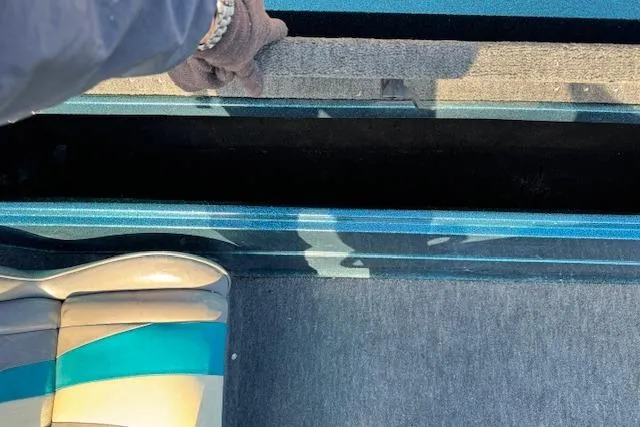 Slide: The Image of 1994 Javelin 389T boat interior with seat and storage compartment. - 18