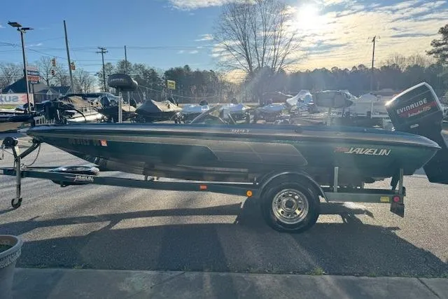 Slide: The Image of 1994 Javelin 389T boat on trailer, parked outdoors under a clear sky. - 3