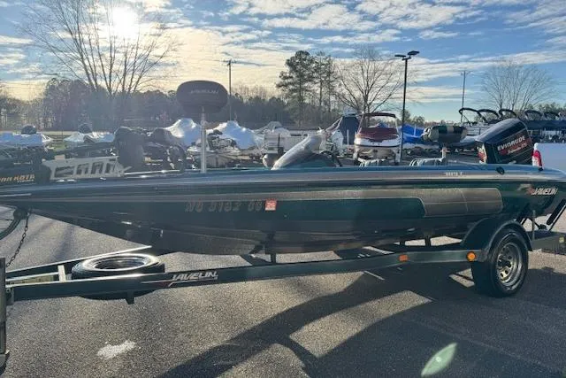 Slide: The Image of 1994 Javelin 389T boat on trailer in sunny outdoor setting. - 4