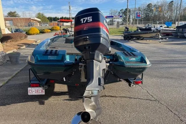 Slide: The Image of 1994 Javelin 389T boat with Evinrude 175 outboard motor, parked outdoors. - 5