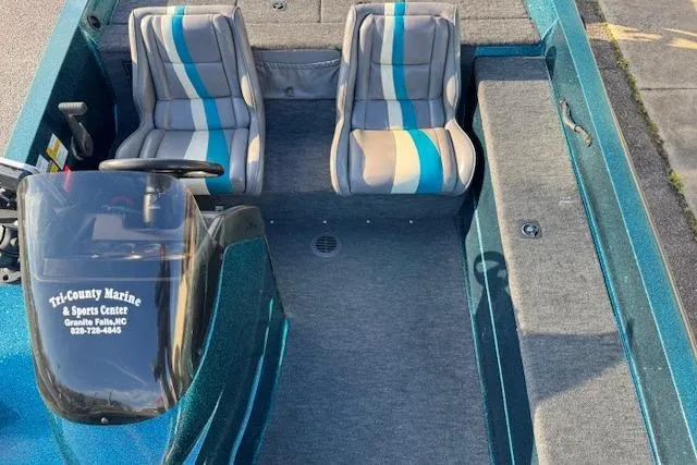 Slide: The Image of 1994 Javelin 389T boat interior with striped seats and steering console. - 8