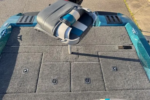 Slide: The Image of 1994 Javelin 389T boat deck with gray carpet and foldable seat. - 9