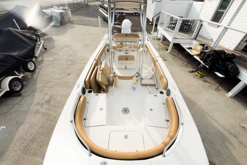 Slide: The Image of 2025 Carolina Skiff 21 Ultra Elite boat with tan seating, docked outdoors. - 10