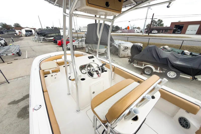 Slide: The Image of 2025 Carolina Skiff 21 Ultra Elite boat interior with tan seating and steering console. - 12