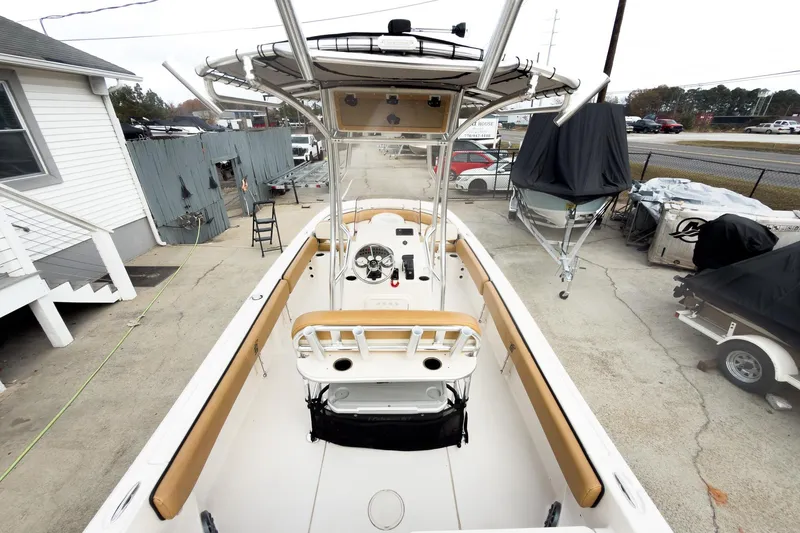 Slide: The Image of 2025 Carolina Skiff 21 Ultra Elite boat, docked, showcasing spacious interior and helm. - 13