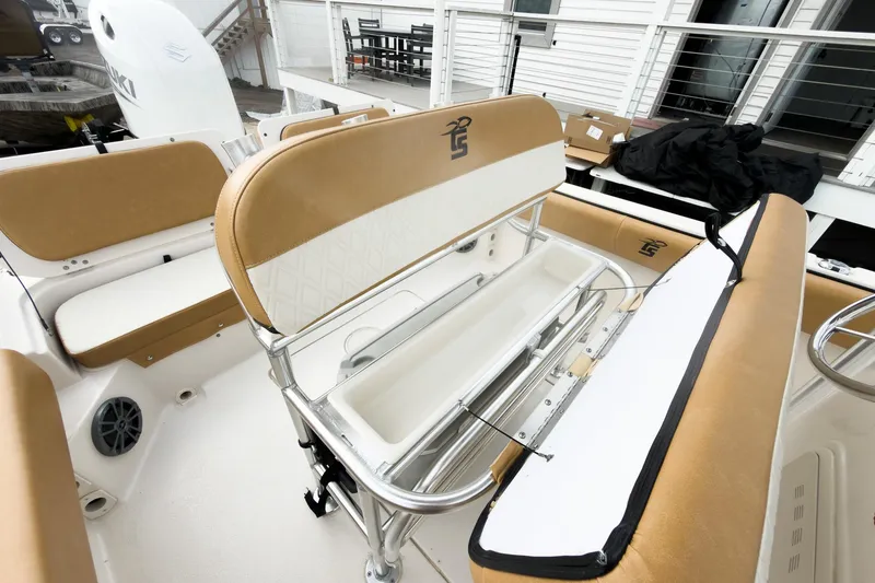 Slide: The Image of 2025 Carolina Skiff 21 Ultra Elite boat interior with tan seating and storage compartments. - 16