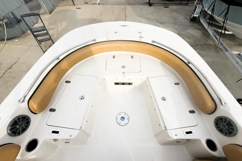 Slide: The Image of 2025 Carolina Skiff 21 Ultra Elite boat interior with tan seating and storage compartments. - 25