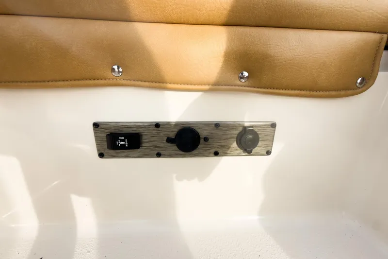 Slide: The Image of 2025 Carolina Skiff 21 Ultra Elite boat interior with control panel and tan upholstery. - 27