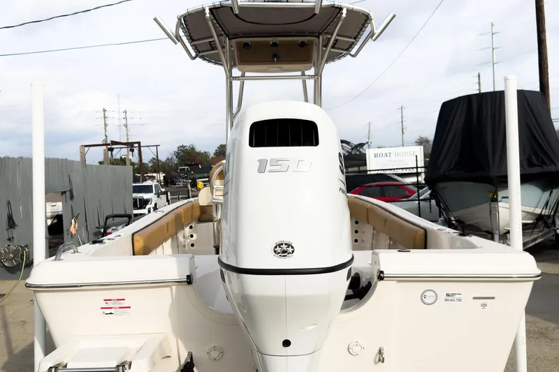 Slide: The Image of 2025 Carolina Skiff 21 Ultra Elite boat with 150 horsepower engine, docked outdoors. - 6
