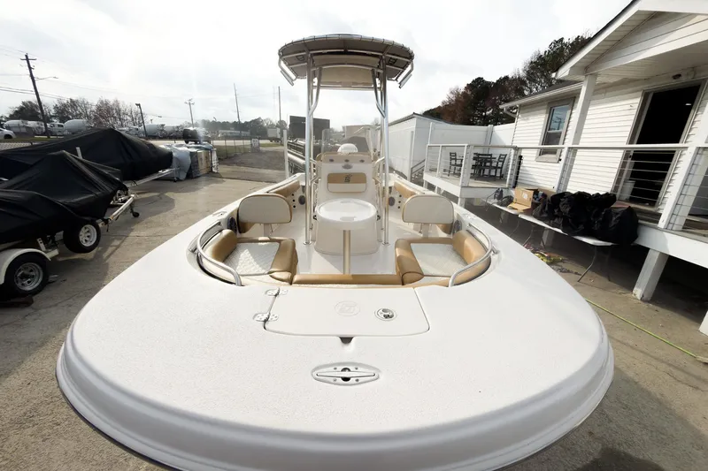 Slide: The Image of 2025 Carolina Skiff 21 Ultra Elite boat docked, showcasing spacious deck and seating. - 8