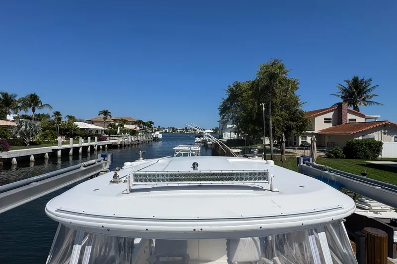 Slide: The Image of 2005 Century 3200 Walk-Around boat docked in a scenic canal with waterfront homes. - 11