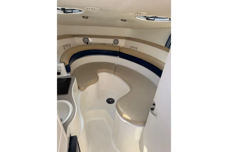 Slide: The Image of Interior of 2005 Century 3200 Walk-Around boat with beige and blue seating. - 12