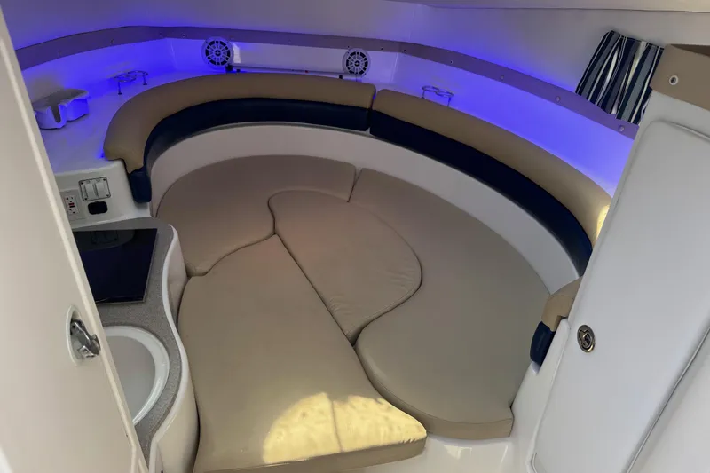 Slide: The Image of Interior of a 2005 Century 3200 Walk-Around boat with cozy seating and ambient lighting. - 14