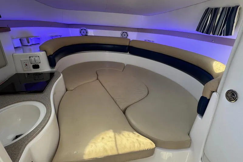 Slide: The Image of Interior of a 2005 Century 3200 Walk-Around boat with cozy seating and ambient lighting. - 16