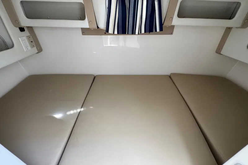 Slide: The Image of Interior cabin of 2005 Century 3200 Walk-Around boat with beige cushions. - 17