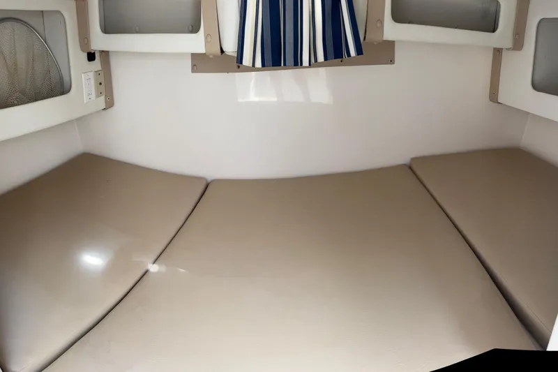 Slide: The Image of Interior cabin of a 2005 Century 3200 Walk-Around boat with beige cushions. - 18