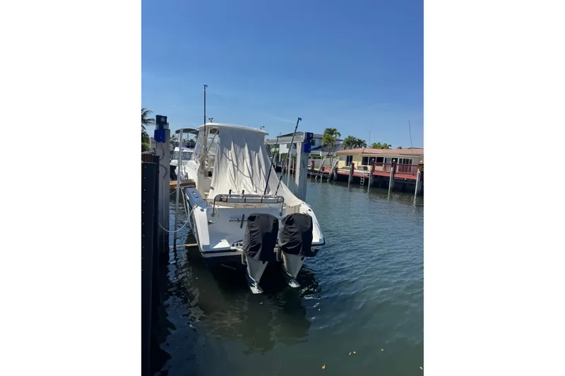 Slide: The Image of 2005 Century 3200 Walk-Around boat docked in a sunny marina. - 2