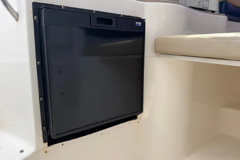 Slide: The Image of 2005 Century 3200 Walk-Around boat interior with built-in black refrigerator. - 25