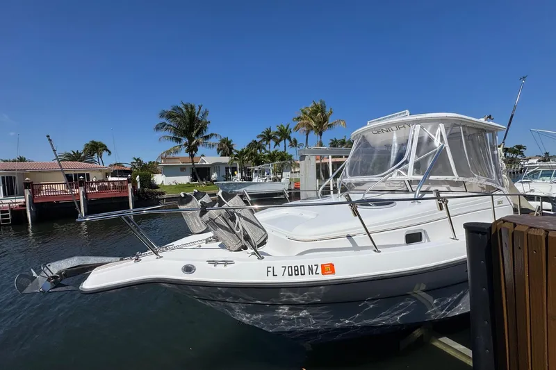 Slide: The Image of 2005 Century 3200 Walk-Around boat docked in a sunny marina setting. - 3