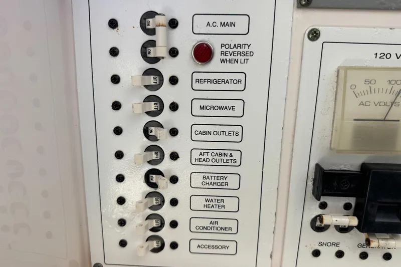 Slide: The Image of Electrical panel of a 2005 Century 3200 Walk-Around boat with labeled switches and voltmeter. - 30