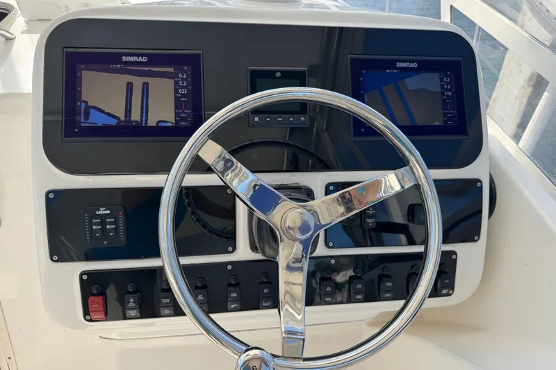 Slide: The Image of Steering console of a 2005 Century 3200 Walk-Around boat with dual Simrad displays. - 33