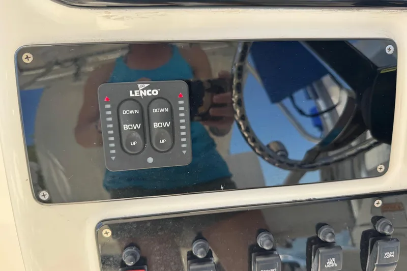 Slide: The Image of Control panel of a 2005 Century 3200 Walk-Around boat with Lenco trim tab switches. - 37