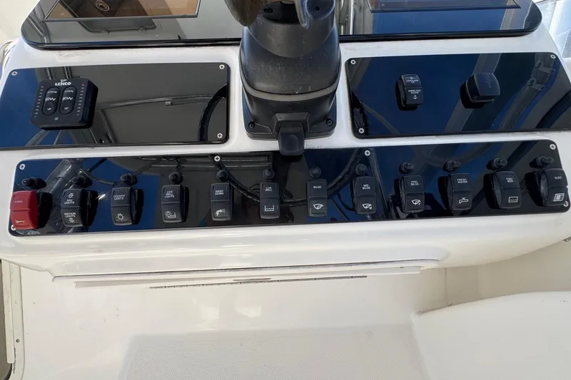 Slide: The Image of Control panel of a 2005 Century 3200 Walk-Around boat with various switches and buttons. - 38