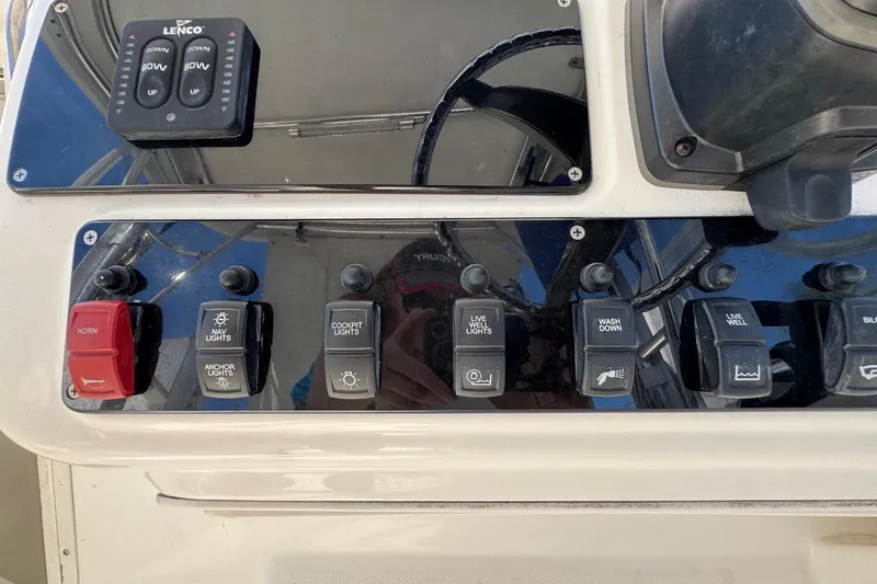 Slide: The Image of Control panel of a 2005 Century 3200 Walk-Around boat with various switches. - 39