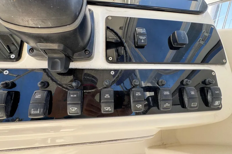 Slide: The Image of Control panel of a 2005 Century 3200 Walk-Around boat with various switches. - 40