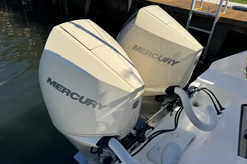 Slide: The Image of Twin Mercury outboard engines on a 2005 Century 3200 Walk-Around boat at dock. - 45