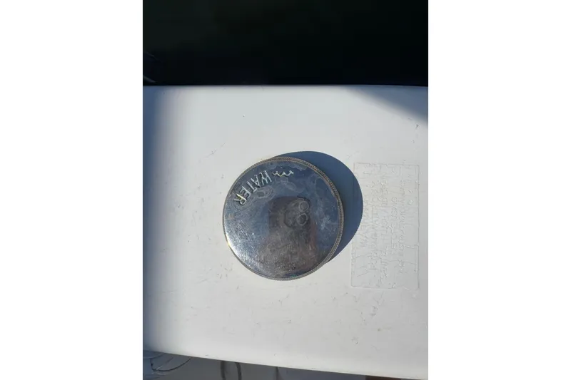 Slide: The Image of Fuel cap on a 2005 Century 3200 Walk-Around boat, marked "WATER." - 47