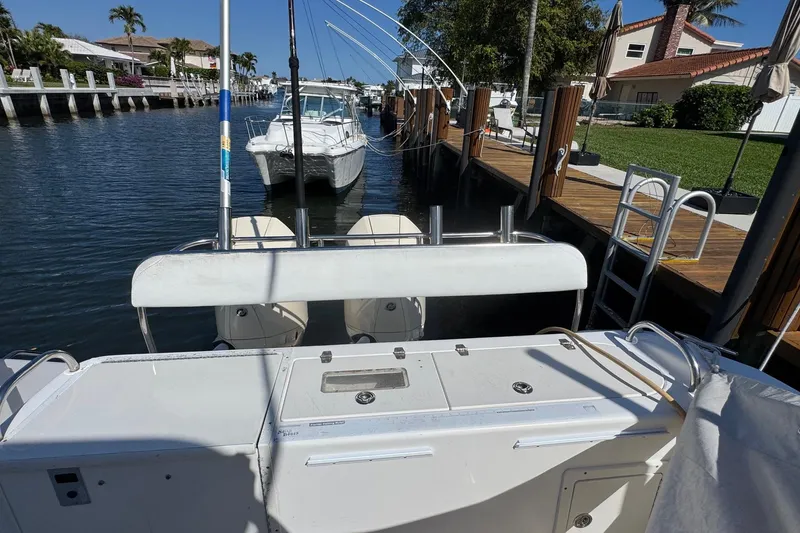 Slide: The Image of 2005 Century 3200 Walk-Around boat docked in a sunny canal setting. - 49