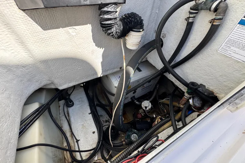 Slide: The Image of Engine compartment of a 2005 Century 3200 Walk-Around boat, showing hoses and wiring. - 51