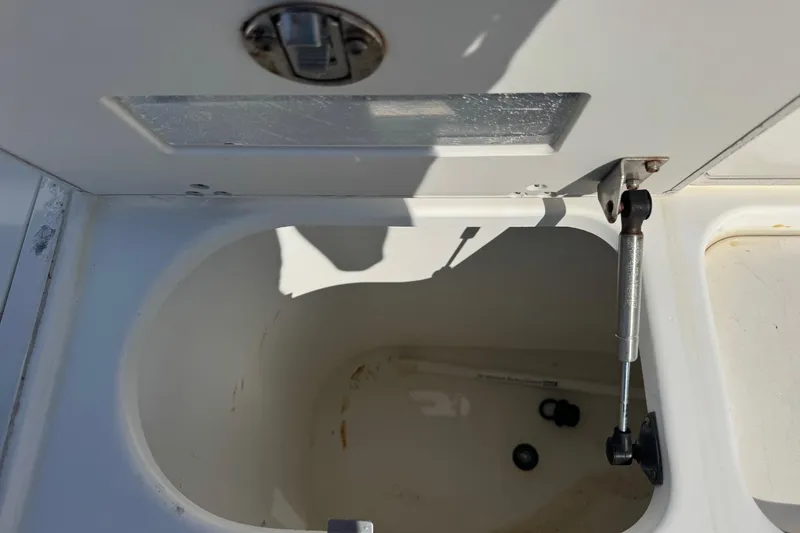Slide: The Image of Open storage compartment on a 2005 Century 3200 Walk-Around boat. - 52