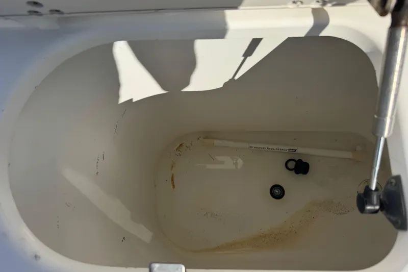 Slide: The Image of Open storage compartment in 2005 Century 3200 Walk-Around boat, showing interior details. - 53