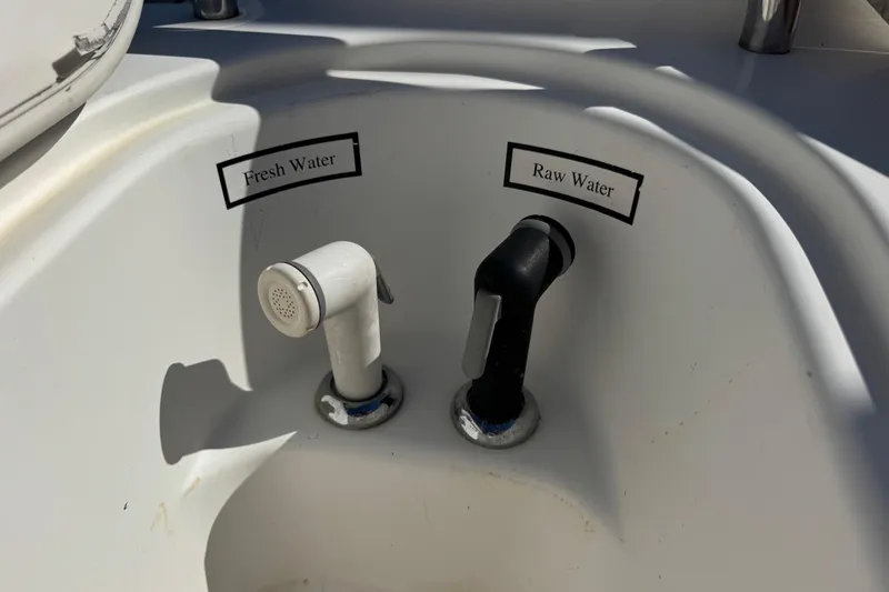 Slide: The Image of Fresh and raw water taps on a 2005 Century 3200 Walk-Around boat. - 55