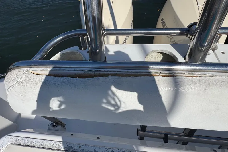 Slide: The Image of 2005 Century 3200 Walk-Around boat with worn upholstery and stainless steel railing. - 57