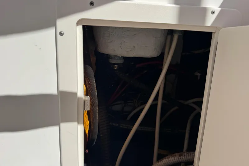 Slide: The Image of Access panel of a 2005 Century 3200 Walk-Around boat, revealing internal wiring and components. - 58