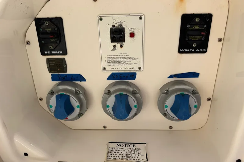 Slide: The Image of Control panel of a 2005 Century 3200 Walk-Around boat with labeled switches and dials. - 59