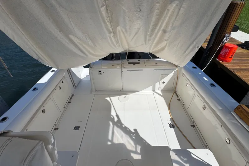 Slide: The Image of 2005 Century 3200 Walk-Around boat interior with white seating and storage compartments. - 6