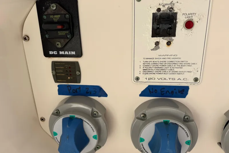 Slide: The Image of Electrical panel on a 2005 Century 3200 Walk-Around boat with labeled switches. - 60