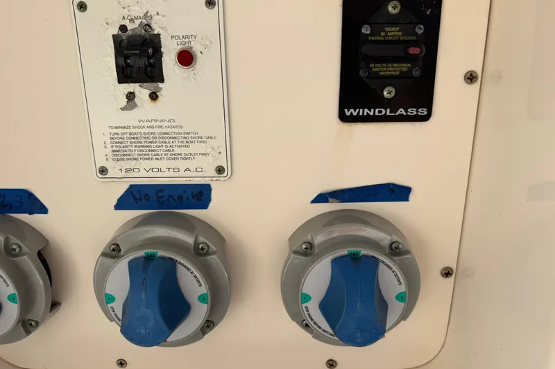 Slide: The Image of Control panel of a 2005 Century 3200 Walk-Around boat with switches and labels. - 61