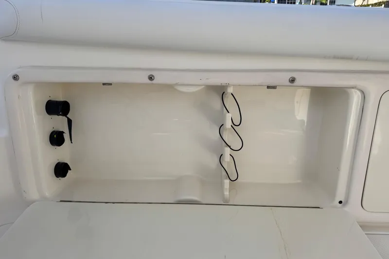 Slide: The Image of Storage compartment on a 2005 Century 3200 Walk-Around boat, featuring utility hooks. - 62