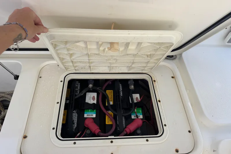 Slide: The Image of Boat battery compartment of a 2005 Century 3200 Walk-Around, lid open, showing wiring. - 64