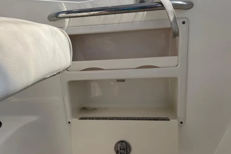 Slide: The Image of Storage compartment on a 2005 Century 3200 Walk-Around boat, featuring a metal handle. - 71