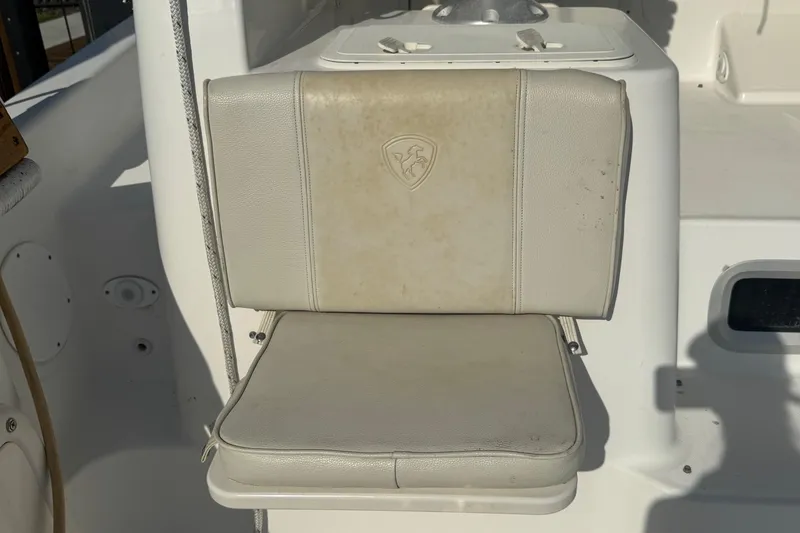 Slide: The Image of Boat seat on a 2005 Century 3200 Walk-Around, featuring a beige cushion. - 76